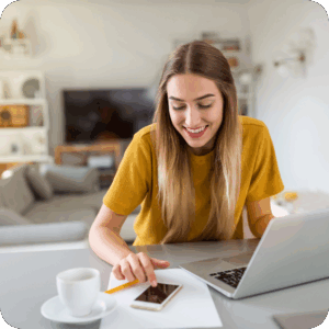 Lächelnde Frau vor Laptop und Handy